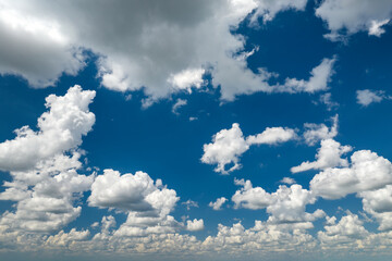 Blue sky with white summer rain clouds. Colorful summer landscape