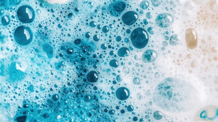 Close-up of blue soap bubbles and foam, showing abstract texture and water droplets in a soapy cleaning solution.