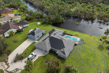 Destroyed by hurricane strong wind private house with damaged rooftop and swimming pool lanai...