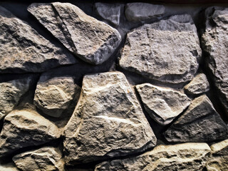 Stone wall texture background and different sized stones     
modern loft design.