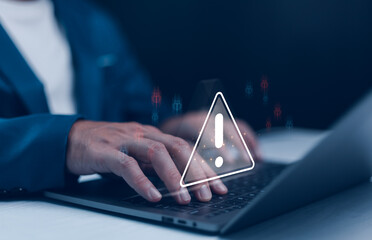 Businessman or it staffs, programmer, developer using laptop with triangle caution warning sign for...