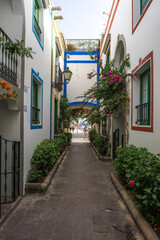 A beautiful alley in Puerto de Mogan. Puerto de Mogan is a picturesque fishing village and popular marina, set on the south-west coast of the island of Gran Canaria. Canary Islands. Spain.
