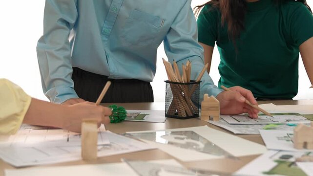 A video of architect use measurement tools and pencil to measure blueprint. Architect design house construction on a table at studio, with architectural plan scattered around. Focus hand. Delineation.
