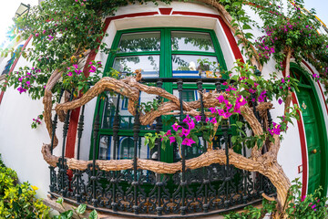 Beautiful facades and windows in Puerto de Mogan. Puerto de Mogan is a picturesque fishing village...