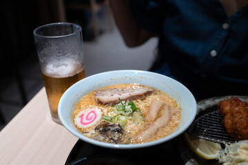 Japanese spicy ramen with beer on the restaurant table
