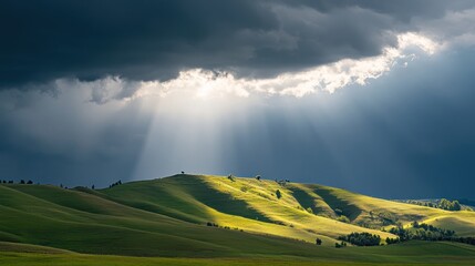 Fototapeta premium Sunbeams Through Storm Clouds Over Rolling Hills
