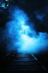 Fototapeta premium A mysterious blue fog enveloping a wooden path through a dense forest, creating an eerie and atmospheric ambiance.