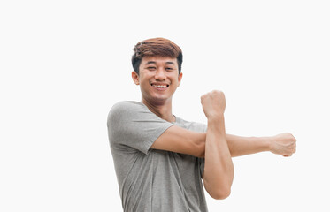 A man stretching his arms or relaxing his muscles. Man in gray t-shirt isolated on gray background....