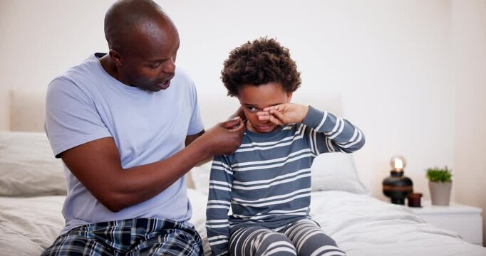 Father, love and crying kid on a bed with stress, anxiety or bullying problem, conversation or console at home. Family, hug and dad comfort sad child in a bedroom with compassion, empathy or sick