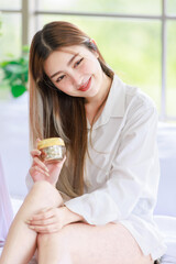 Happy beautiful Asian female  with cosmetics make face take care of skin, Attractive women trying beauty products relax on a white bed, Concept teenage or friends lifestyle at home.