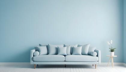 A modern light blue sofa with white throw pillows against a light blue wall.
