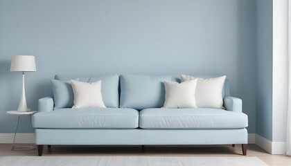 A modern light blue sofa with white throw pillows against a light blue wall.