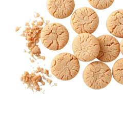 Closeup of small pieces and particles of golden brown sugar cookies scattered on a white background