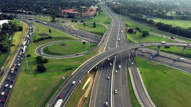 Drone, road and cars on highway of city for travel, transportation and landscape. Infrastructure, cityscape and intersection with ariel view of urban town for street, development and location