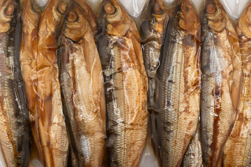 Obraz premium Vacuum packaged smoked fish texture background.