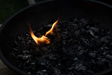 A small light in the darkness among the black coal.