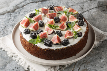 Autumn cake with figs, blackberries and ricotta cheese close-up in a plate on the table. Horizontal