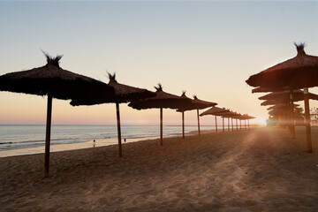 Sunset on the beach with umbrellas