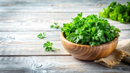 Fototapeta premium Fresh parsley in a wooden bowl on a whitewashed wood background, perfect for rustic food photography