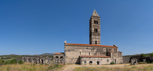 Side view of Basilica della Santissima Trinita di Saccargia with its bell tower, a famous romanesque church in Sassari in Sardinia, Italy with no people, located in the countryside