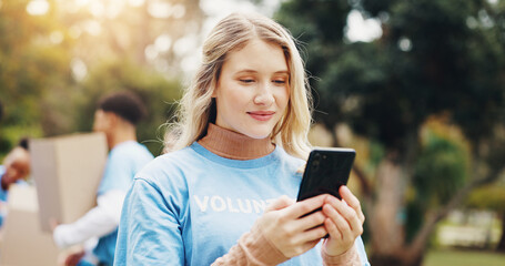 Phone, volunteer and woman in park for charity event, community service and inventory. Volunteering, ngo outreach and person on smartphone for social media, internet and online website outdoors