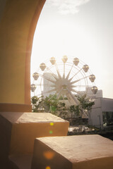 An empty feris wheel at sunset.
