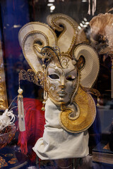 Obraz premium Venetian masks in store display in Venice. Annual carnival in Venice is among the most famous in Europe. Its symbol is the Venetian mask