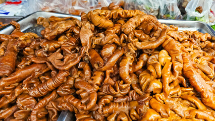 Pile of Pork Chitterlings stew. Thai stewed pork intestines. Braised Pig's Small Intestines & Braised Pork Belly. Galbijjim