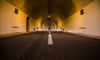 auto tunnel with lights in mountain in switzerland