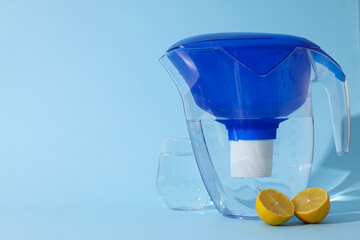 Water filter with fresh lemons and glass