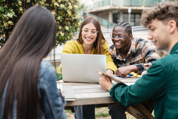 Group of students working and learning together using laptop to study for university exams