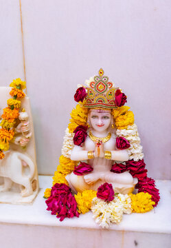 Idol of goddess parvati decorated with rose and marigold flower at temple.