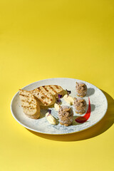 artistic presentation of pate shaped into adorable owls. Served on a plate with toasted bread and garnished with fresh herbs