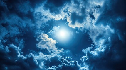 Fototapeta premium Moonlight shining through a break in the clouds, with space for copy.