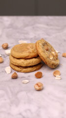 The cookies are golden brown with a slightly crispy edge and a soft, chewy center. Some cookies have chocolate chips