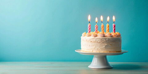 birthday cake with 5 (five) candles on pastel blue background with copyspace