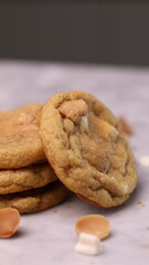 The cookies are golden brown with a slightly crispy edge and a soft, chewy center. Some cookies have chocolate chips