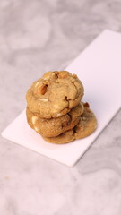 The cookies are golden brown with a slightly crispy edge and a soft, chewy center. Some cookies have chocolate chips