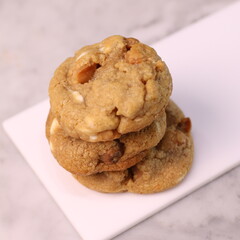 The cookies are golden brown with a slightly crispy edge and a soft, chewy center. Some cookies have chocolate chips