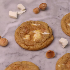 The cookies are golden brown with a slightly crispy edge and a soft, chewy center. Some cookies have chocolate chips