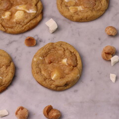 The cookies are golden brown with a slightly crispy edge and a soft, chewy center. Some cookies have chocolate chips