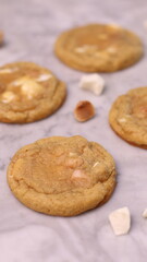 The cookies are golden brown with a slightly crispy edge and a soft, chewy center. Some cookies have chocolate chips