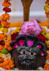 Shivling or shiv lingam decorated with colours and flowers to worship lord shiv. Selective focus.