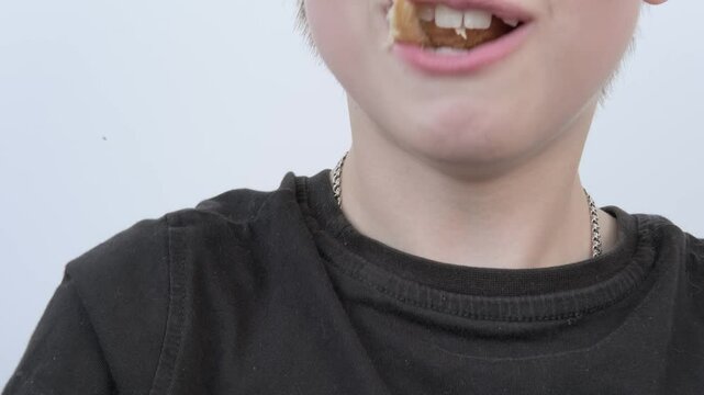 child, Young 10-year-old boy eating fresh croissant, chewing sweets pastry, kid has good appetite, happy childhood, balanced diet, sweet life, unhealthy food