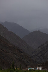 Obraz premium High altitude mountain ranges with covered with low clouds and mist at Ladakh, India on 23 June 2024.