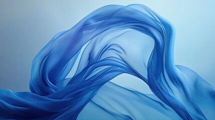 Obraz premium Blue fabric swirling gracefully in mid-air, creating a sense of movement and fluidity