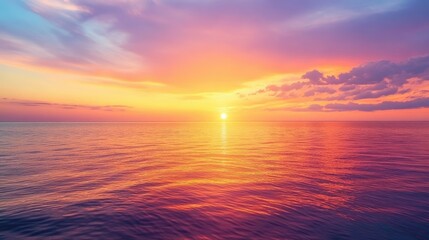 Obraz premium Stunning sunset painting the sky with hues of orange, pink, and purple over a calm horizon