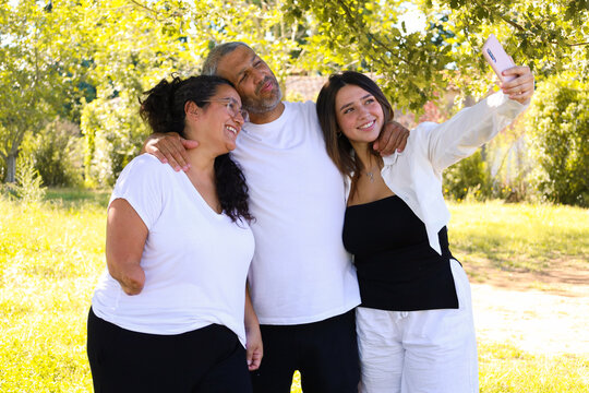 Family with a woman having an arm amputation taking a selfie