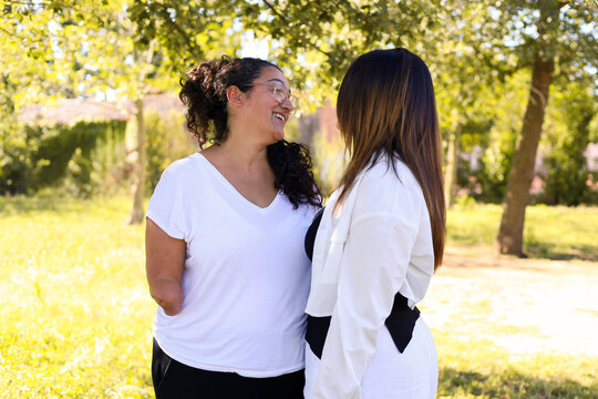 Warm interaction between two women, one with an arm amputation