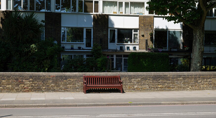 London - 06 14 2022: Burgundy bench in Grosvenor Rd